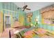 Bright bedroom with mint green striped walls and yellow trim at 817 Antonette Ave, Winter Park, FL 32789