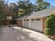 Three-car garage with brick driveway and basketball hoop at 817 Antonette Ave, Winter Park, FL 32789