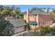 Two-story house with a peach exterior, gray roof, and detached garage at 817 Antonette Ave, Winter Park, FL 32789