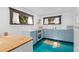 Small kitchen with light blue cabinets and teal floors at 817 Antonette Ave, Winter Park, FL 32789