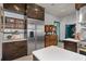 Stainless steel refrigerator and dark wood cabinets in this kitchen at 817 Antonette Ave, Winter Park, FL 32789