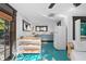 Modern kitchen with teal floors and white and blue cabinetry at 817 Antonette Ave, Winter Park, FL 32789