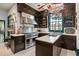 Stainless steel appliances and dark wood cabinetry highlight this kitchen at 817 Antonette Ave, Winter Park, FL 32789