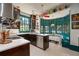 Kitchen with teal accents, stainless steel appliances, and a mix of vintage and modern styles at 817 Antonette Ave, Winter Park, FL 32789