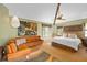 Main bedroom with king bed, leather sectional and large windows at 817 Antonette Ave, Winter Park, FL 32789