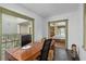 Home office with built-in desk and view into bedroom at 817 Antonette Ave, Winter Park, FL 32789