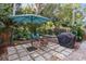 Patio with stone paving, table, chairs, umbrella, and grill at 817 Antonette Ave, Winter Park, FL 32789