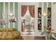 Green striped sitting room with French doors opening to sunroom at 817 Antonette Ave, Winter Park, FL 32789