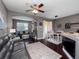 Open concept living and dining area with dark hardwood floors at 890 Assembly Ct, Reunion, FL 34747