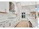 White kitchen with stainless steel appliances and quartz counters at 1062 Liliana Dr, Deland, FL 32724