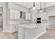Island kitchen with white cabinets and quartz countertops at 1062 Liliana Dr, Deland, FL 32724