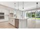 Island kitchen with white cabinets and stainless steel appliances at 1062 Liliana Dr, Deland, FL 32724