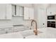 Quartz countertops, white cabinets, and modern gold faucet at 1062 Liliana Dr, Deland, FL 32724