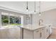 Modern kitchen with white cabinets, marble countertops, and a large island at 1062 Liliana Dr, Deland, FL 32724