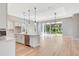 Open concept kitchen with island and sliding glass doors at 1062 Liliana Dr, Deland, FL 32724