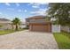 Two-story house with a large driveway and garage at 11815 Pethrick Dr, Orlando, FL 32824