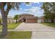 Two-story house with a two car garage and large driveway at 11815 Pethrick Dr, Orlando, FL 32824