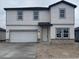 Two-story house with light gray siding, two-car garage, and stone accents at 1421 Arbor Hill Dr, Deltona, FL 32725