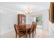 Dining room with a large wooden table, hutch, and chandelier at 1447 Malaluka St, Deltona, FL 32725