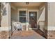 Welcoming front porch with rocking chair and decorative wreath at 16085 Pebble Bluff Loop, Winter Garden, FL 34787