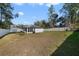 Large backyard with a spacious grassy area and privacy fence at 1630 W New York Ave, Orange City, FL 32763