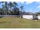 Backyard with grassy lawn and white fence at 1630 W New York Ave, Orange City, FL 32763