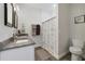 Bathroom with granite countertop, double sinks, and shower at 1630 W New York Ave, Orange City, FL 32763