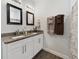 Bathroom with double vanity, granite countertop, and shower at 1630 W New York Ave, Orange City, FL 32763