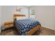 Bedroom with wood bed frame and patterned bedding at 1630 W New York Ave, Orange City, FL 32763