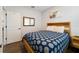 Bedroom with wood bed frame and patterned bedding at 1630 W New York Ave, Orange City, FL 32763