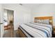 Bedroom with wood bed frame and striped bedding at 1630 W New York Ave, Orange City, FL 32763