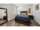 Bright bedroom with a wooden bed frame and neutral decor at 1630 W New York Ave, Orange City, FL 32763