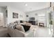 Comfortable living room with light-colored couches and a large TV at 1630 W New York Ave, Orange City, FL 32763