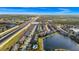 Aerial view of townhouses community near a highway and lake at 1927 Chatham Place Dr, Orlando, FL 32824