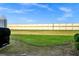 Backyard view showing grassy lawn and high wall at 1927 Chatham Place Dr, Orlando, FL 32824