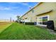 Townhome back with grassy yard, privacy fence, and grill at 1927 Chatham Place Dr, Orlando, FL 32824