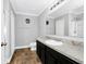 Bathroom with dark vanity, granite countertop, and a large mirror at 1927 Chatham Place Dr, Orlando, FL 32824