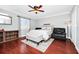 Cozy bedroom with a queen bed, hardwood floors, and a ceiling fan at 1927 Chatham Place Dr, Orlando, FL 32824