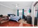Bedroom with a bed, desk, and hardwood floors at 1927 Chatham Place Dr, Orlando, FL 32824