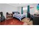 Bedroom with a bed, desk, and hardwood floors at 1927 Chatham Place Dr, Orlando, FL 32824