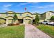 Two-story townhome with two-car garage and landscaped front yard at 1927 Chatham Place Dr, Orlando, FL 32824