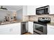 Eat-in kitchen with stainless steel appliances and granite countertops at 1927 Chatham Place Dr, Orlando, FL 32824