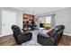 Living room with hardwood floors, comfortable seating, and home office at 1927 Chatham Place Dr, Orlando, FL 32824