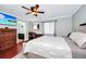 Main bedroom with king-size bed, hardwood floors, and ensuite bathroom at 1927 Chatham Place Dr, Orlando, FL 32824