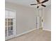 Spacious bedroom with tile floor, sliding door to patio, and ceiling fan at 1964 Lake Atriums Cir # 175, Orlando, FL 32839