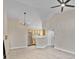 Open living room and kitchen with vaulted ceilings and tile floors at 1964 Lake Atriums Cir # 175, Orlando, FL 32839