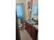 Bathroom with light blue vanity and teal shower curtain at 2035 W Gore St, Orlando, FL 32805