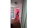 Hallway with wood floors and doors to bedrooms at 2035 W Gore St, Orlando, FL 32805