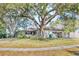 House exterior showcasing a ranch-style home with a large tree at 2481 Lake Helen Osteen Rd, Deltona, FL 32738