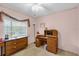 Cozy bedroom featuring natural light from a large window and a dedicated work space at 2712 Ceram Ave, Orlando, FL 32837